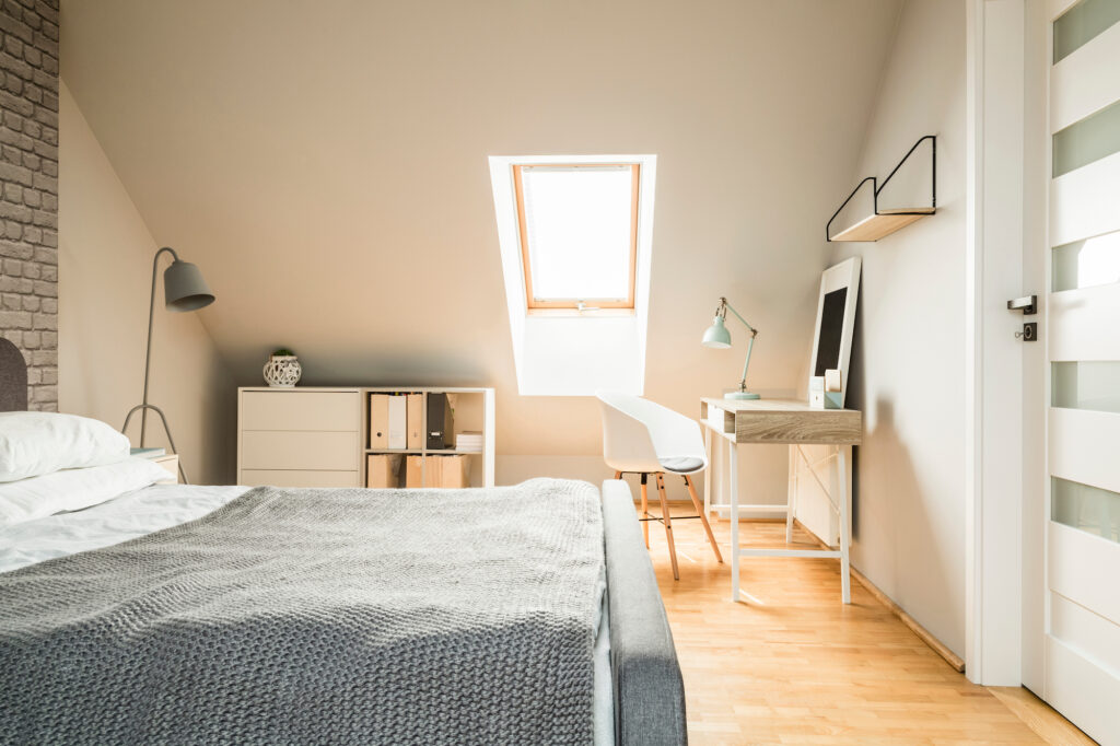Picture of a loft bedroom with wooden floors and skylight